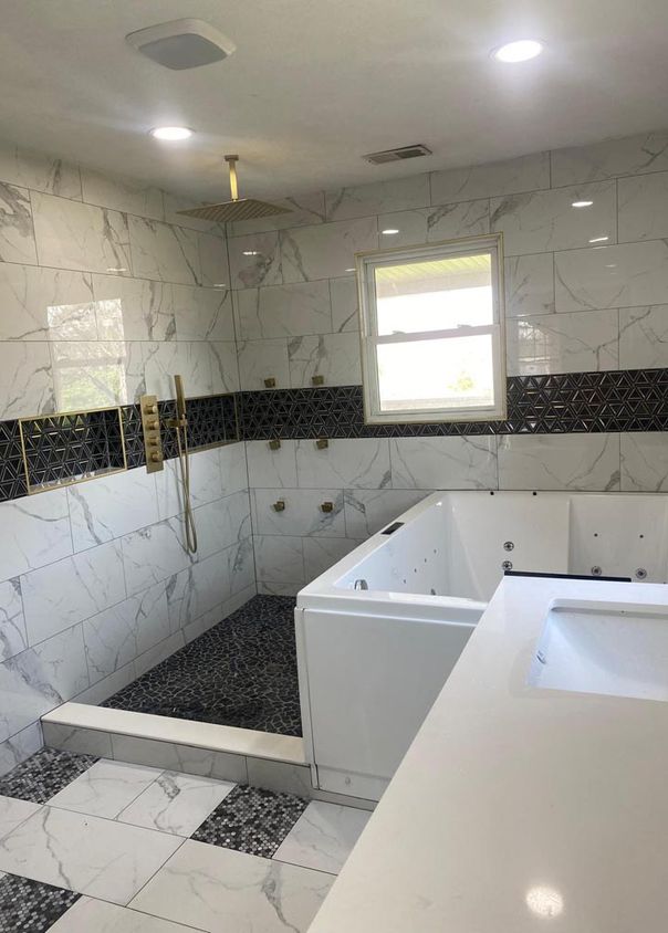 Spacious bathroom remodel with walk-in shower, jetted tub, and gold fixtures